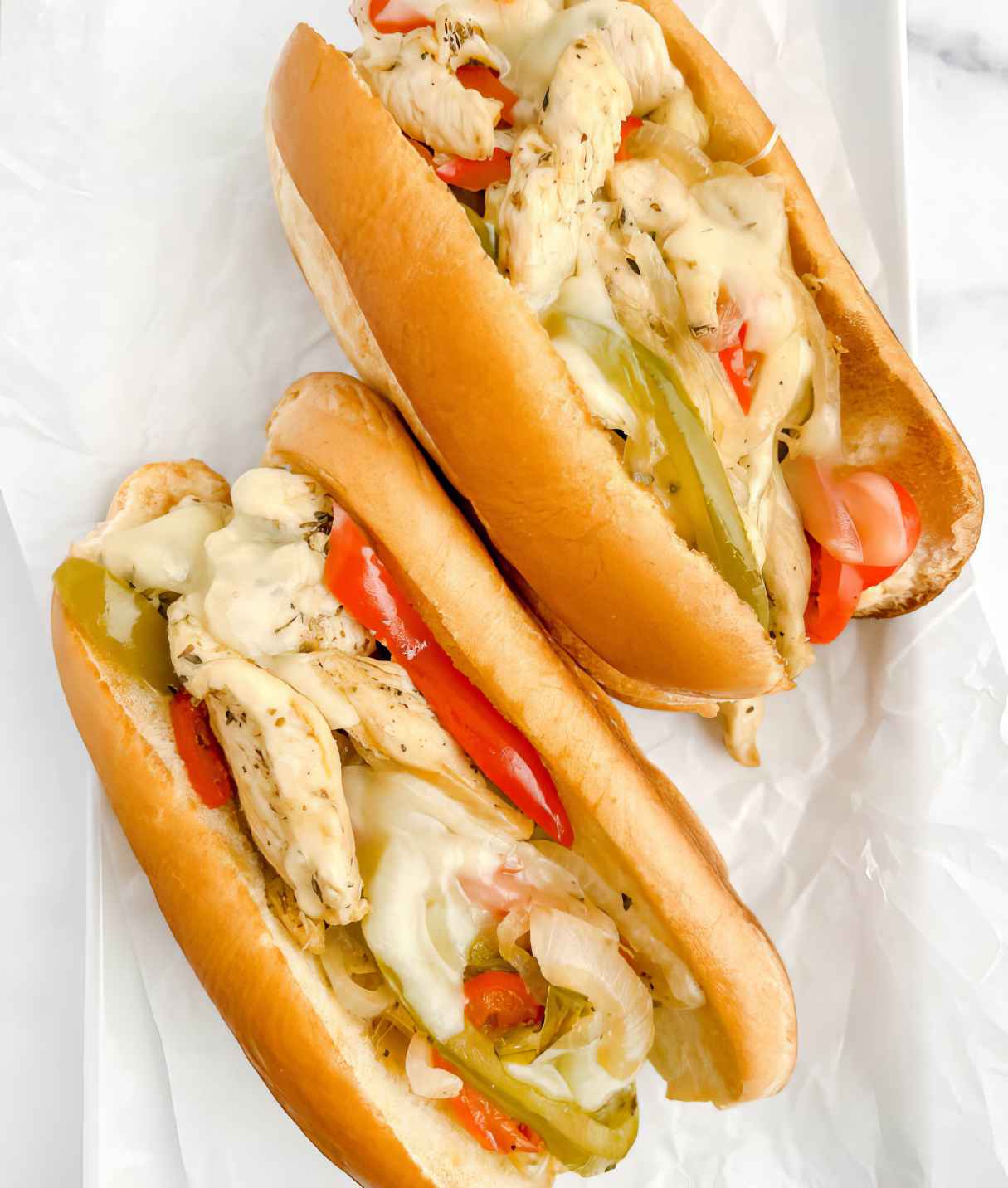 Chicken Cheesesteak Sandwiches with Onions, Bell Peppers, and Melty Cheese